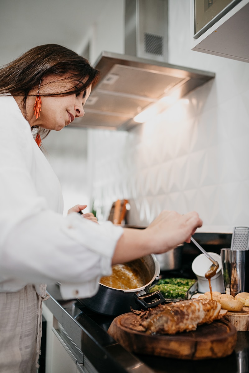 Photo by Vitor Monthay woman in white long sleeve shirt holding silver fork